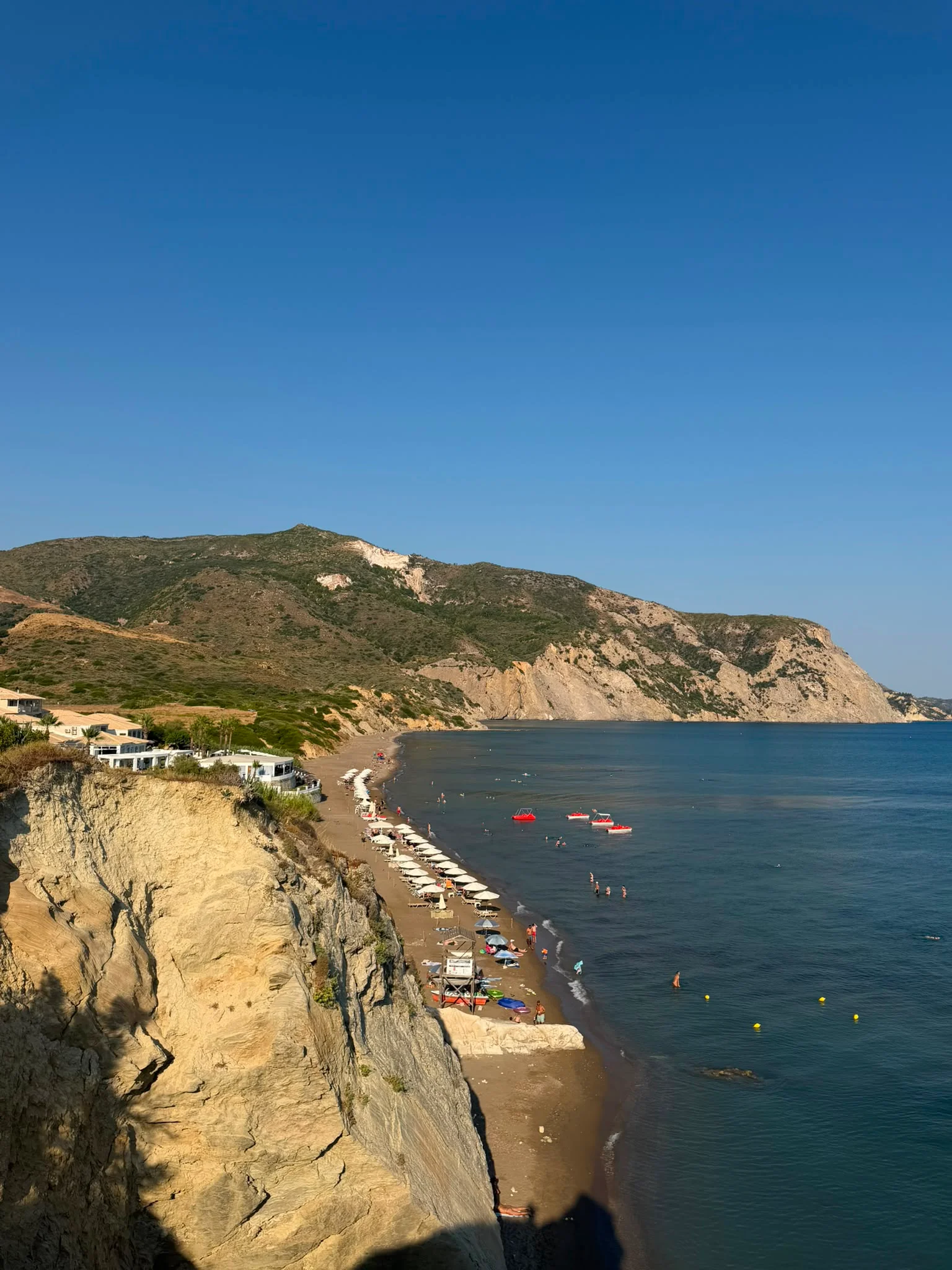 The sweep of Crystal Beach below the sandstone cliffs, with the headland stretching away to the south